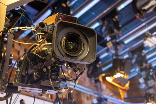 Studio camera with professional lighting hang under the ceiling, ready for broadcasting or video recording