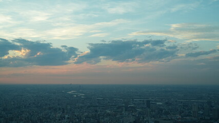 The panoramic city view from the top of the skyscraper building with the sunset sky as background