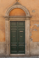 old wooden door in a stone wall Rome