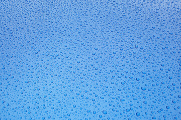Blue Water Droplets Cover a Smooth Surface for a Glossy, Abstract Background