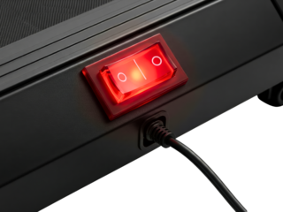 Red illuminated power switch on black treadmill base on a transparent background