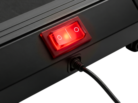 Red illuminated power switch on black treadmill base on a transparent background
