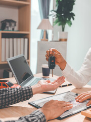 Fototapeta premium In the leasing concept, the car broker will assist the customer and explain the contact details about the car, car keys, buying or selling, signing insurance documents.