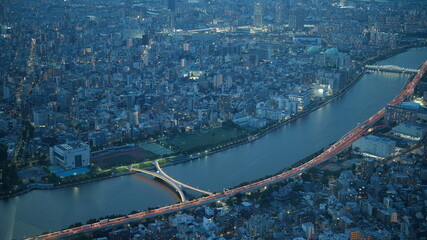 The beautiful city night view from the top of one skyscraper with the lights on at night