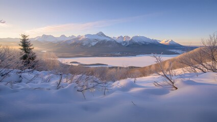 Snowy mountain landscape with a frozen lake at sunrise
