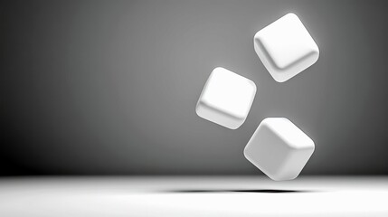 Three smooth, white, rounded cubes are suspended in mid-air against a gradient gray background. The scene is lit with soft, diffused light, creating subtle shad
