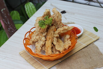 Fried tempeh in an orange basket served on the table