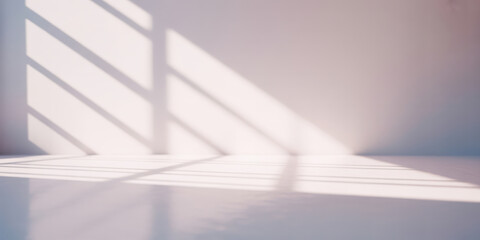 Obraz premium Minimalist background with soft diffused natural light casting geometric shadows on white wall