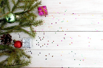 There is a Christmas decoration on a white wooden background.