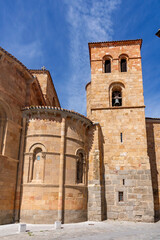 Fototapeta premium The Romanesque Church of San Pedro in Ávila, built of warm, golden stone, features a large central rose window, a triple-arched entrance, and low, sculpted stone lions
