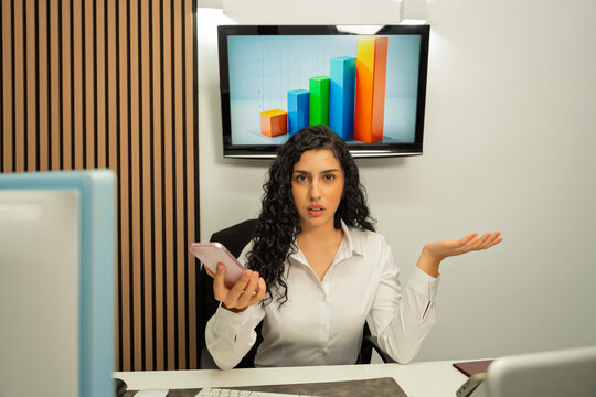 Businesswoman showing confusion about financial bar chart data