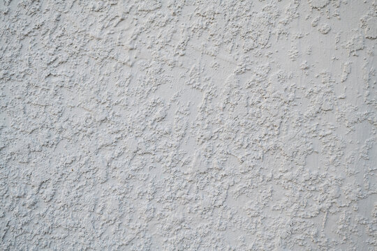 White stucco wall texture background on South Florida home outside. white stucco wall texture on house exterior, outside of home stucco texture background
