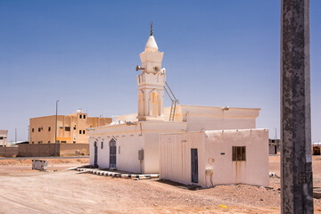 

Small village mosque in Saudi Arabia, fully white with its minaret and loudspeakers