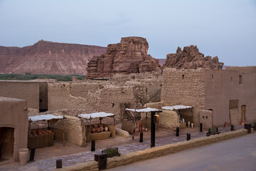 View of terracotta shops along Al Ula street at sunset