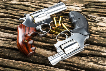 Revolver guns and bullets on wooden background , Pocket gun or Concealed pistol