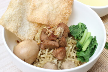 Asian food menu: chicken noodles and dumplings served in bowls.