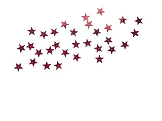 Scattered red and burgundy glitter stars confetti creating a dynamic corner border on a neutral light white background with ample copy space.