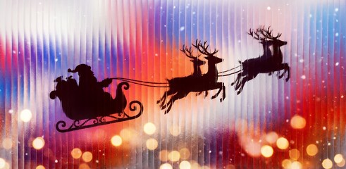 Silhouette of Santa Claus and reindeer sleigh flying behind colorful ribbed glass.