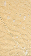 sea waves on yellow sand. background or texture