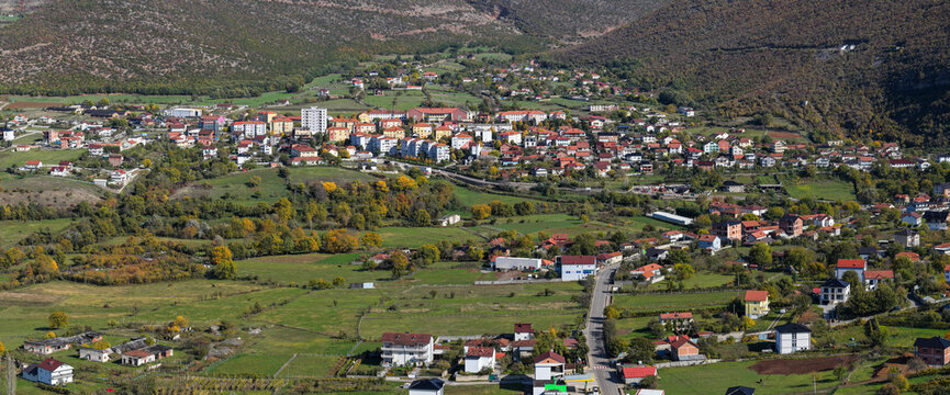 Aerial view of Krumë and surrounding green fields at the foothills of the mountains in northern Albania.