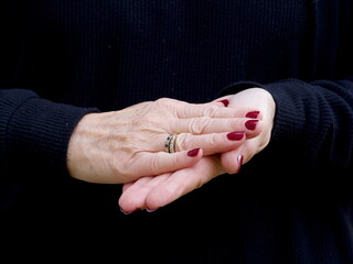 A pair of hands signing the consonant letter 'H' in British Sign Language.Hand moves across palm.BSL.Communication.Hearing Impaired.