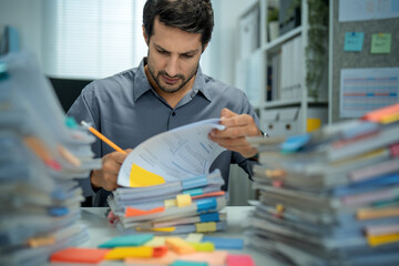 Stressed tired businessman with headache working late on laptop. Overworked entrepreneur facing deadline pressure and burnout in office.