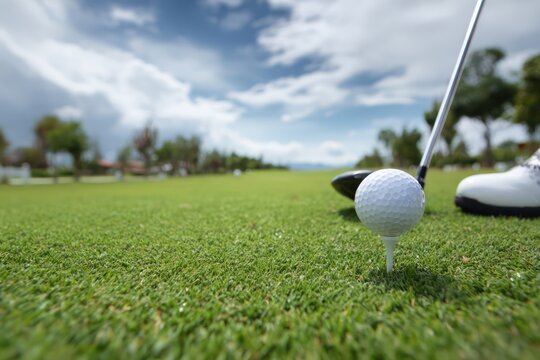 Golfer Preparing to Tee Off on a Pristine Green Golf Course