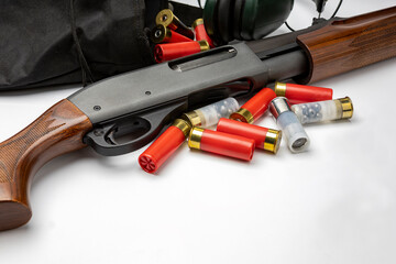 Pump action of shotgun and bullets on white background