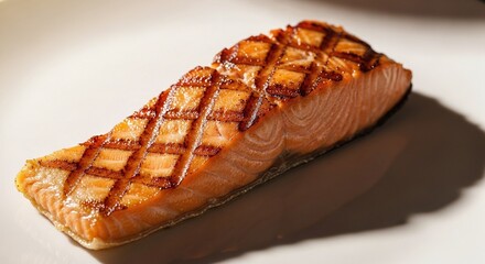 A perfectly grilled salmon fillet sits on a white plate, its skin marked with a beautiful diamond pattern from the grill, the flesh a vibrant orange, casting a soft shadow on the pristine surface