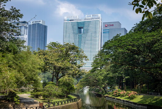 Kuala Lumpur, Malaysia - May 25, 2025:&nbsp; Cimb bank headquarters, St Regis and Sentral luxurious hotel buildings in financial city centre. Green scenic public Perdana botanical park in front. 
