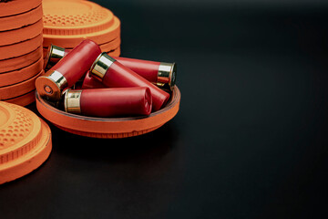 Clay disc flying targets and shotgun bullets on black background ,Clay Pigeon target