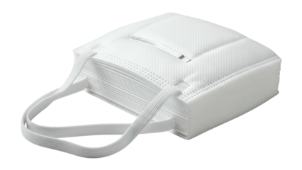 Stack of white protective face coverings, with elastic straps, lying on surface
