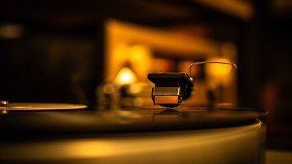 Close-up of spinning vinyl record on turntable, capturing motion of grooves and stylus. Classic analog music setup evokes nostalgia, creativity and warm sound