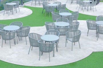 Outdoor Woven Bistro Set with Table and Chairs in an Open Space