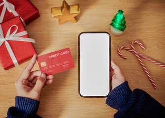 Holiday online shopping with smartphone and credit card enabling secure digital payments festive e-commerce purchases seamless mobile transactions and modern seasonal consumer behavior
