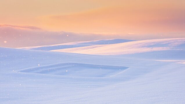 Snow covered rolling hills with soft orange sky winter