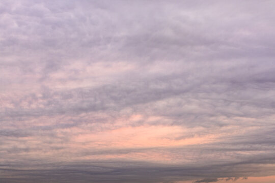 gray and pink cloudy sky in warm autumn dusk