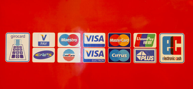 Berlin, Germany - July 17, 2025: Payment method logos displayed on bright red background for transactions