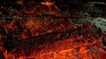 Close-up of Hot Embers with Flying Sparks . Concept of heating grills or ovens