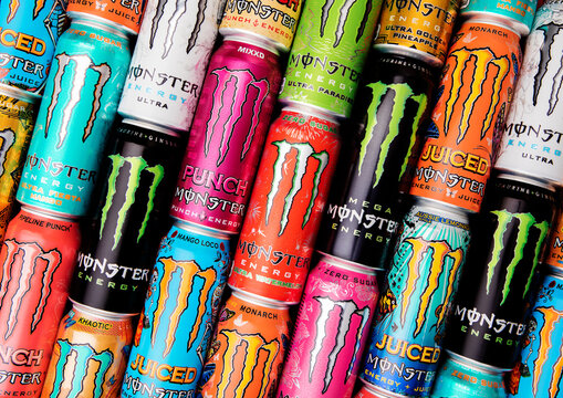 LONDON,UK - AUGUST 01, 2025: Assorted Monster energy soft drinks in aluminum tins with various flavors and taste.Top view.