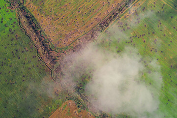 High-angle aerial view of modern military field fortifications, including defensive trenches, dugouts, and earthwork structures used by troops. Conceptual photo for war, conflict, and defense strategy