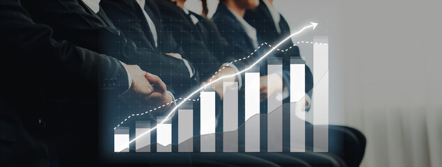 A professional business meeting showcasing a positive growth trend through a digital chart, highlighting successful strategies and collaborative efforts in a corporate setting. Axiom