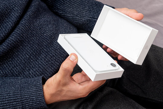 Bar, Montenegro, 2 November 2025, Man unboxing open box new smartphone iphone
