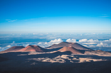 Volcanic cones above the cloud layer on the high-altitude slopes of Mauna Kea, Hawaii Island, USA