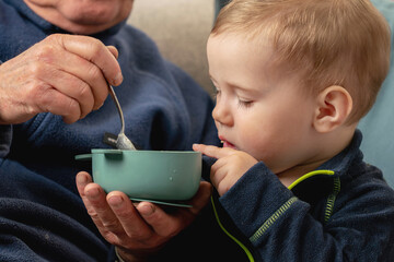 Warm family connection across generations, elder man caring for a child.