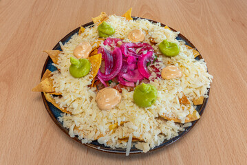 nachos with sautéed garlic shrimp, diced avocado, and mango habanero salsa