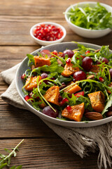 Close up of oven baked pumpkin salad wooden surface