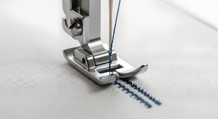 Sewing machine needle stitching fabric with blue thread close-up