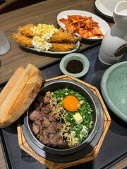 Hearty rice bowl served alongside crispy flavorful dishes.
