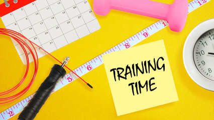 Training Time Reminder with Fitness Equipment on Yellow Background. Exercise Planning Concept with Calendar, Dumbbell and Jump Rope